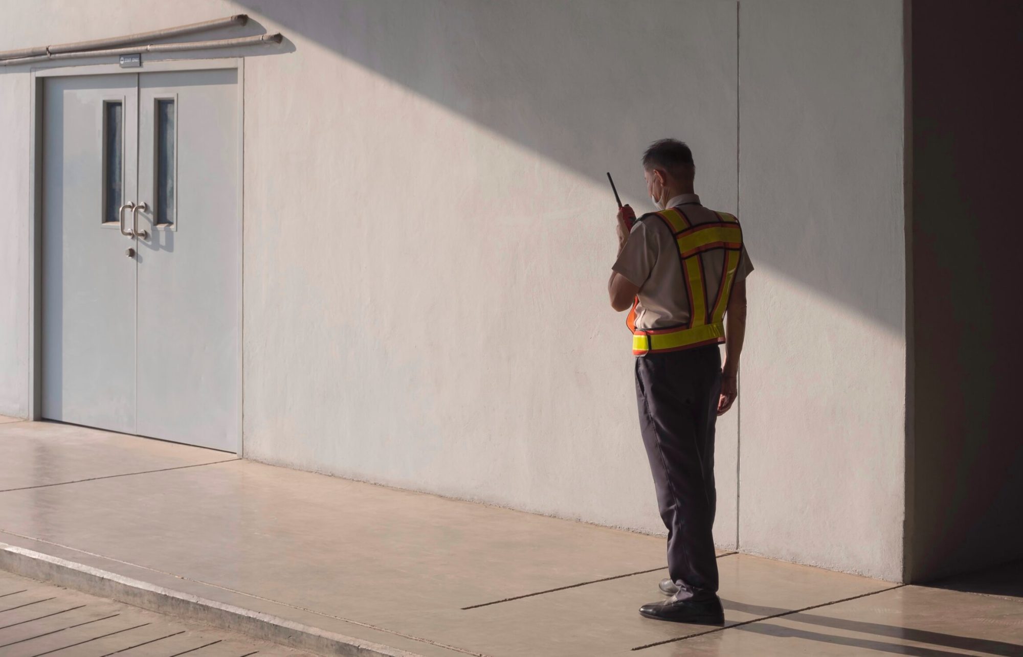 security-guard-using-walkie-talkie-while-working-i-2022-11-04-00-19-45-utc